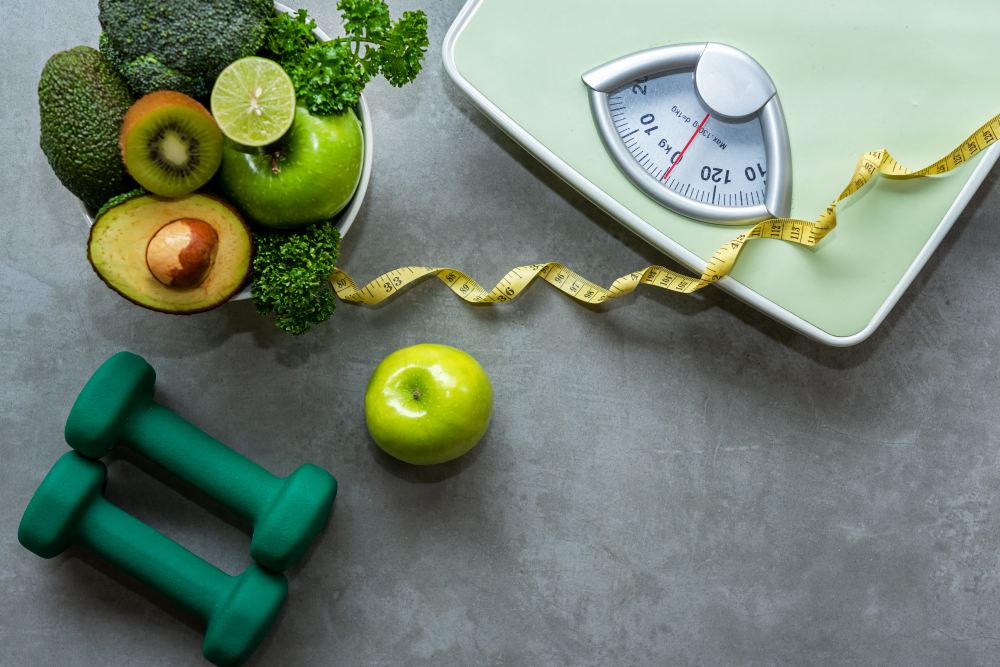 Shutterstock_1220319118 Diet and Healthy life loss weight slim Concept. Organic Green apple and Weight scale measure tap with nutrition vegan vegetable and sport equipment gym for body women diet fit. Top view copy space.