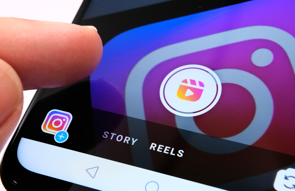 Shutterstock_1806996049 Stone / UK - August 31 2020: Instagram Reels seen in Instagram app on mobile phone and finger pointing at it. New feature from Facebook aimed to create competition with TikTok.
