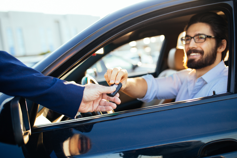 Shutterstock_752921596 Young and handsome businessman buying used car